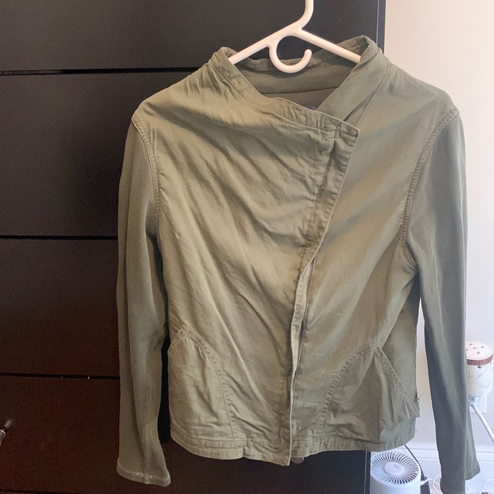 Army green jacket with cotton sleeves and some natural fraying.